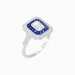 Load image into Gallery viewer, Art Deco Inspired Emerald Cut Halo Ring with Calibré Gems