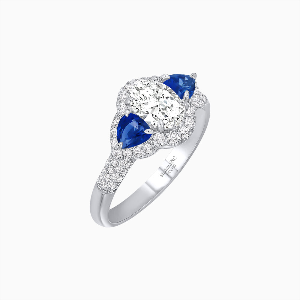 Three-Stone Oval Ring with Pear Shape Side Stones and Diamond Halo